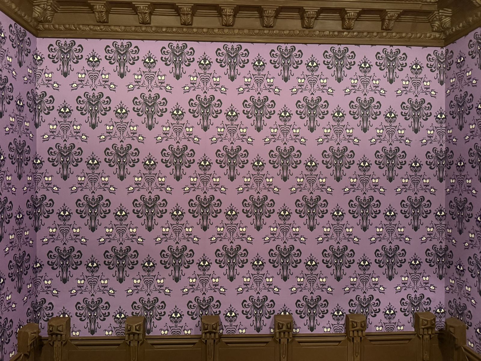 The same room with Haunted Mansion damask wallpaper installed above the panelling
